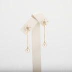 Dangle pearl earrings on a white background
