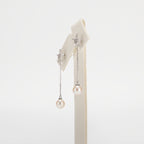 Dangle pearl earrings on a white background