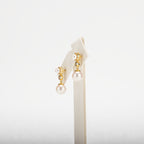 Pearl earring with decorative elements on a white background