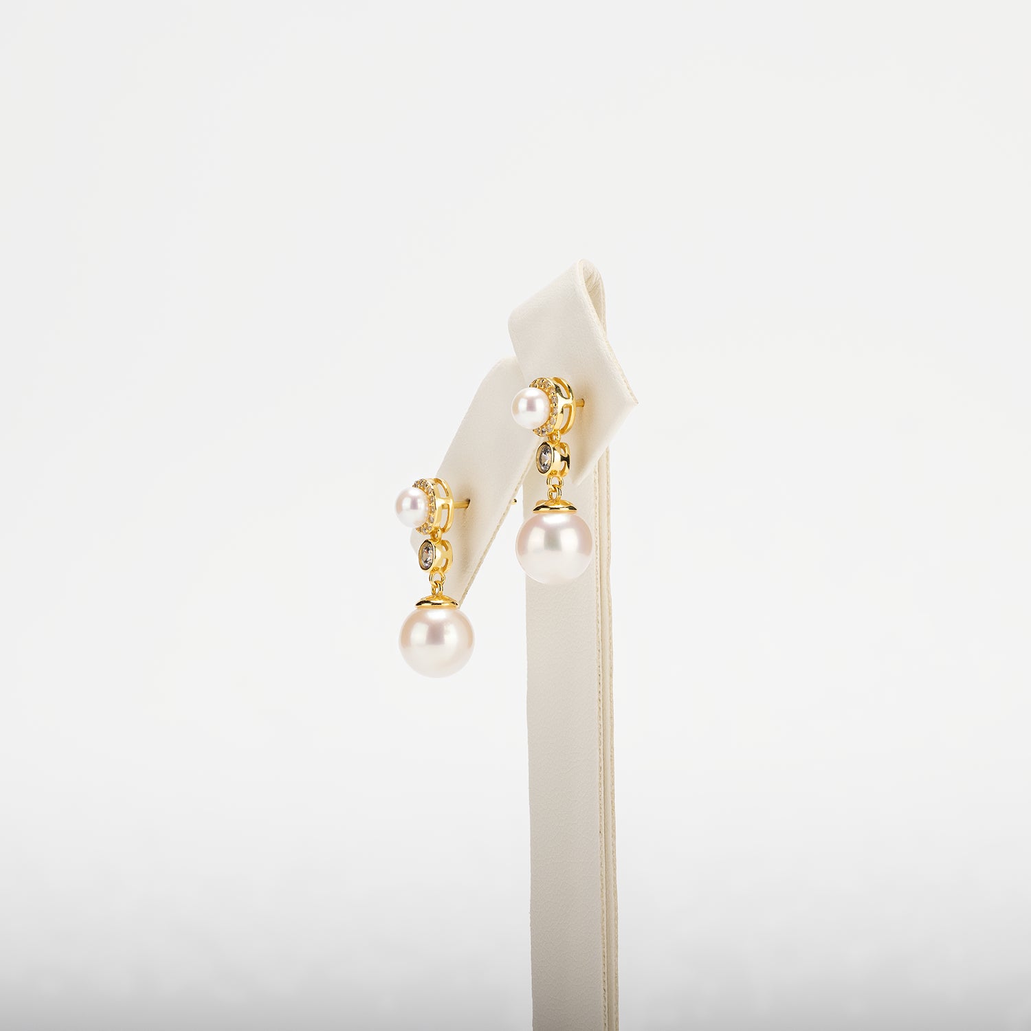 Pearl earring with decorative elements on a white background