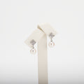 Pearl earrings with cubic zirconia on a  white background