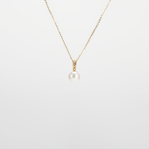 Pearl Drop Necklace with gold chain on a light gray background