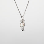 A robot-shaped pearl  pendant necklace on a white background