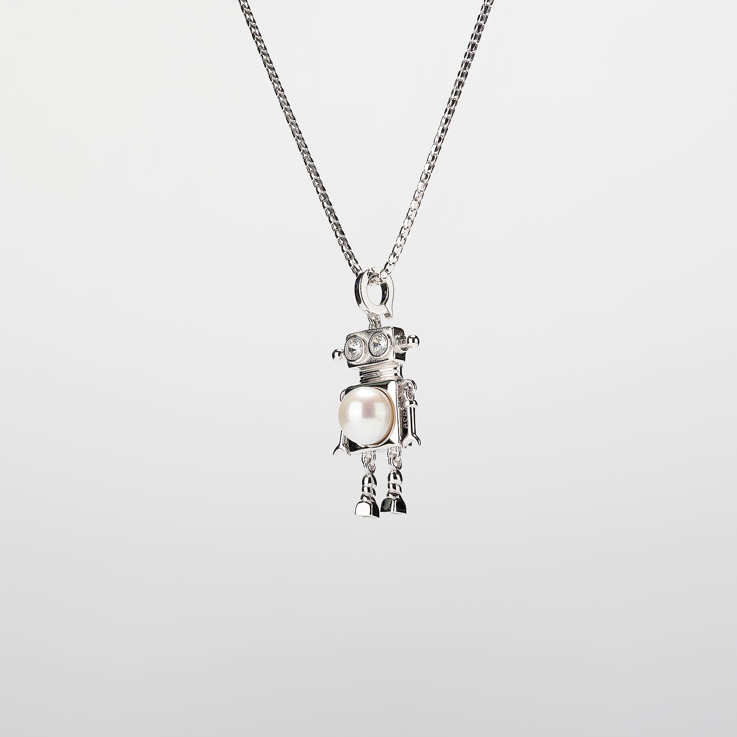 A robot-shaped pearl  pendant necklace on a white background