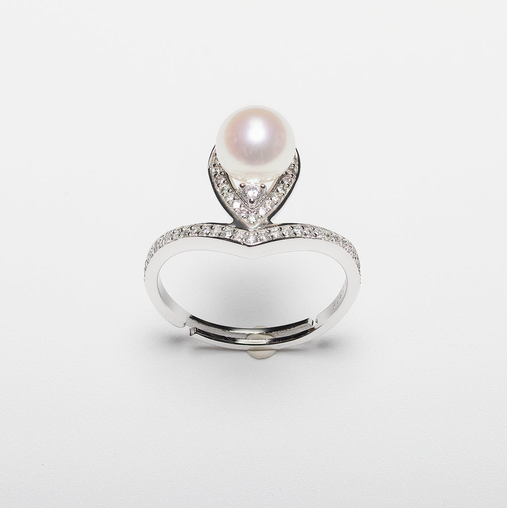 Pearl ring with cubic zirconia on a white background