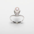 Pearl ring with cubic zirconia on a white background