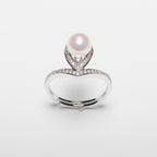 Pearl ring with cubic zirconia on a white background