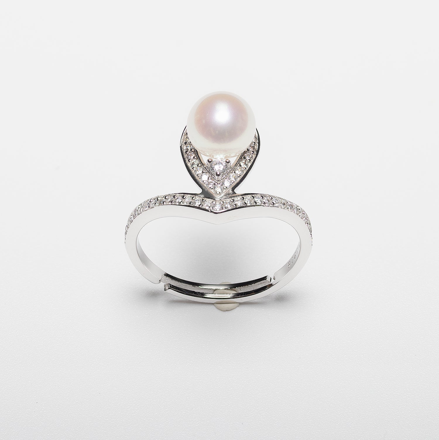 Pearl ring with cubic zirconia on a white background