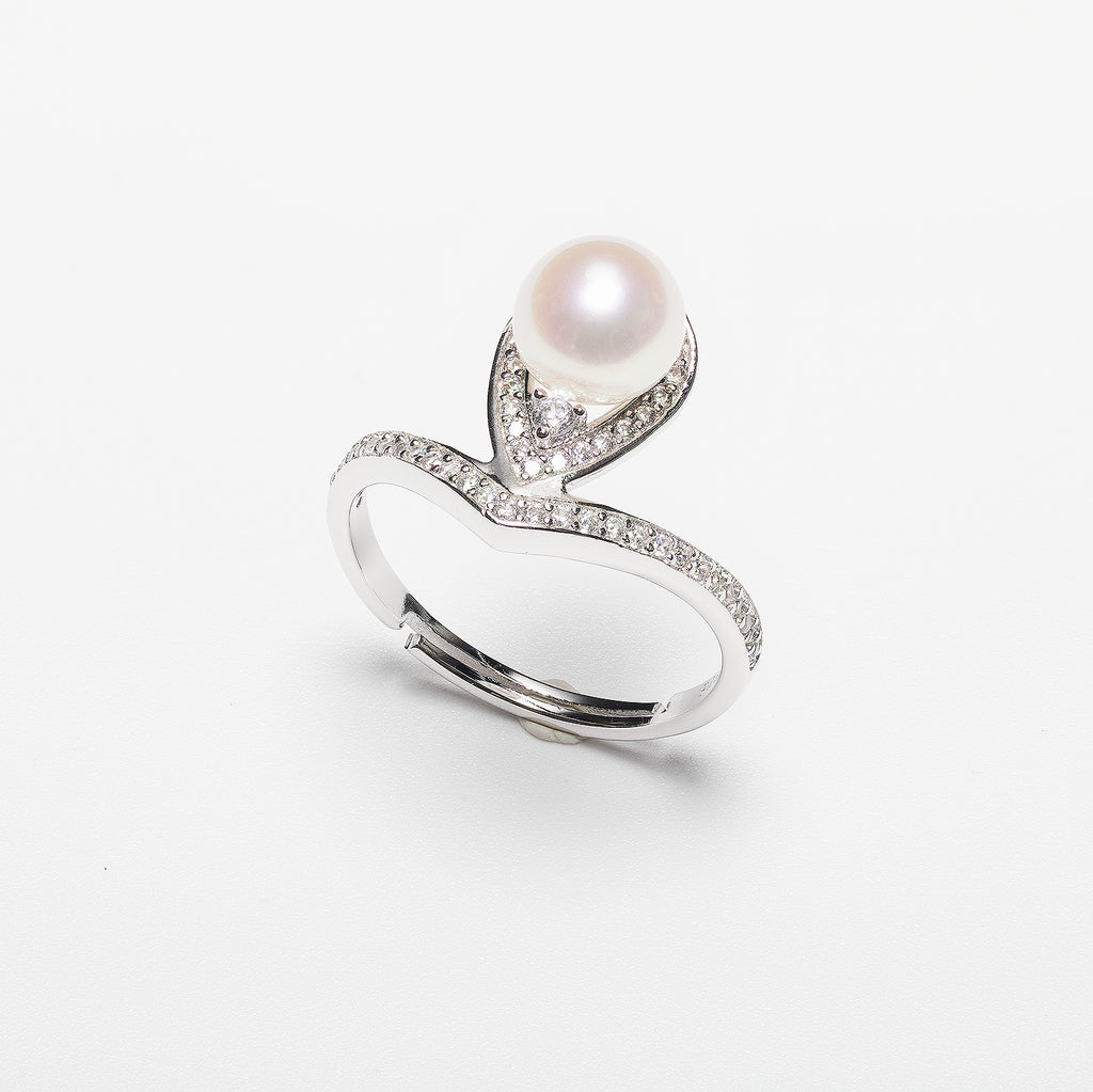 Pearl ring with cubic zirconia on a white background