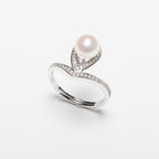 Pearl ring with cubic zirconia on a white background