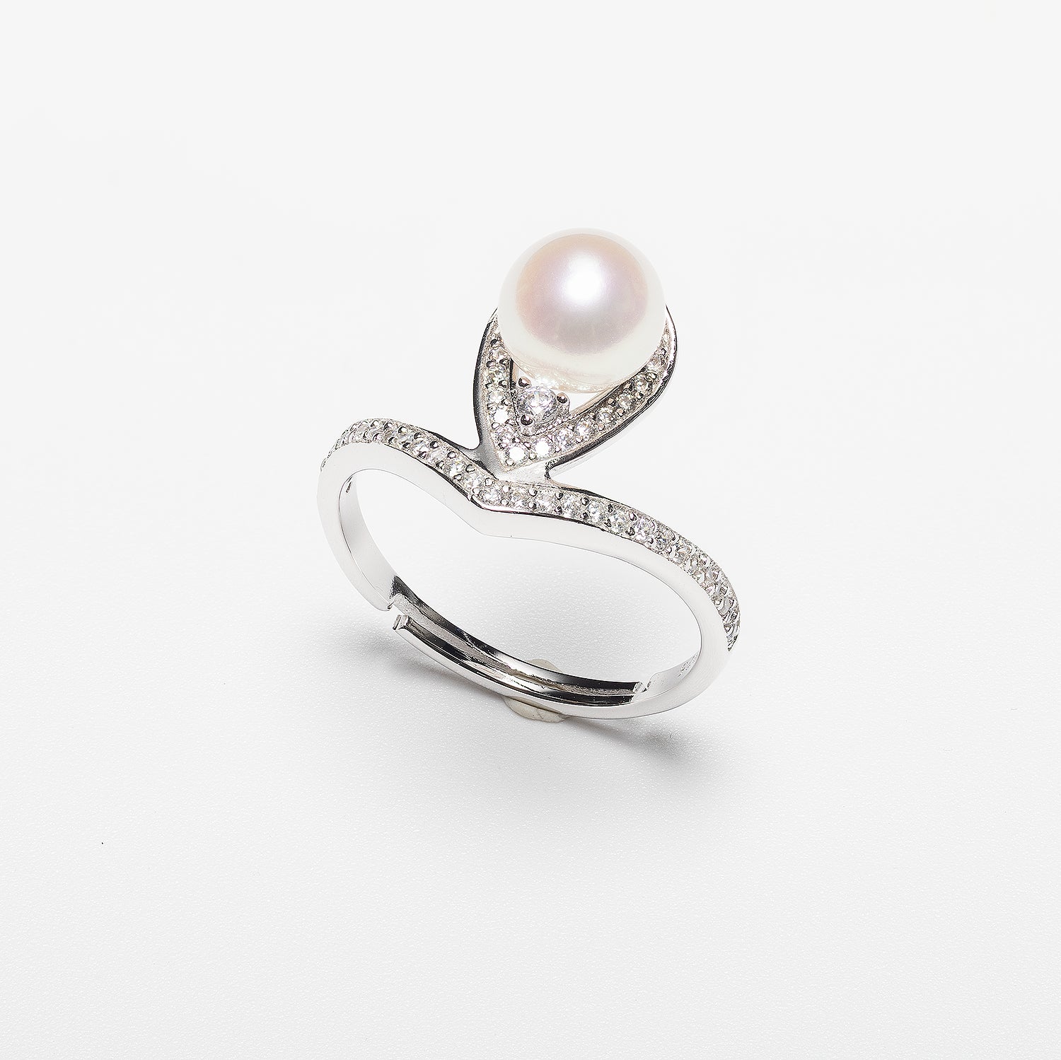 Pearl ring with cubic zirconia on a white background