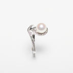 Pearl ring with diamond accents on a white background