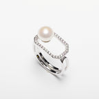Pearl ring with cubic zirconia on a white background