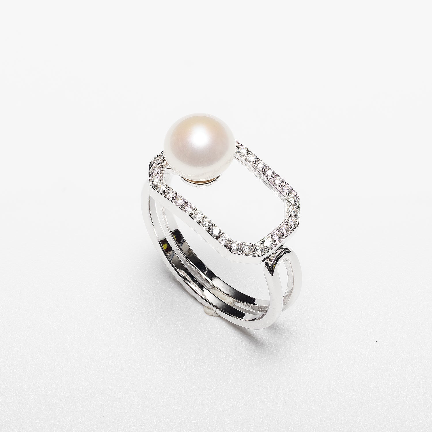 Pearl ring with cubic zirconia on a white background